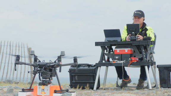 Man flies with drone to deliver package