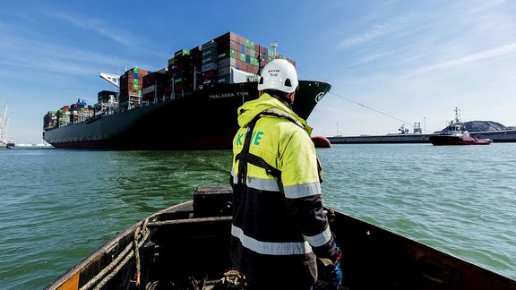 Rower looks at ship