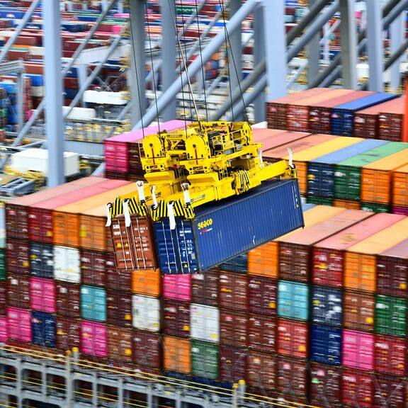 Containers are unloaded in pairs from the ship off the quay